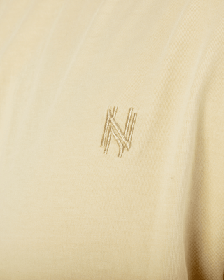 Cream-colored T-shirt by New Heritage.